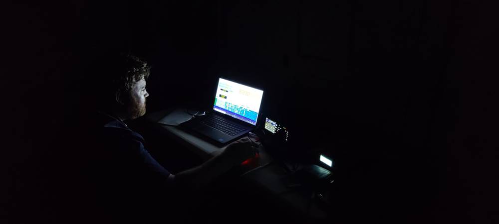 Student tests radio on computer in the dark